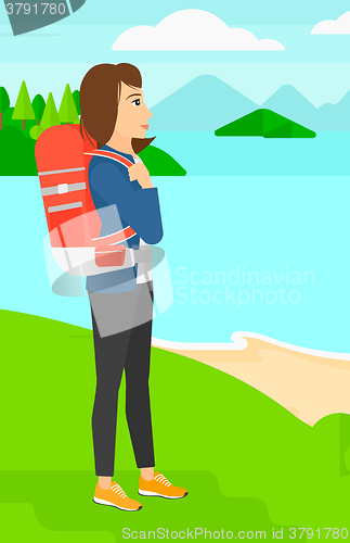Image of Woman with backpack hiking.
