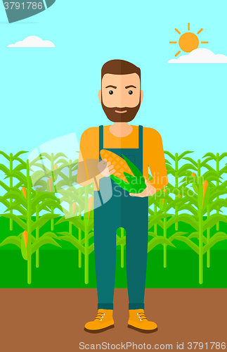 Image of Farmer holding corn.