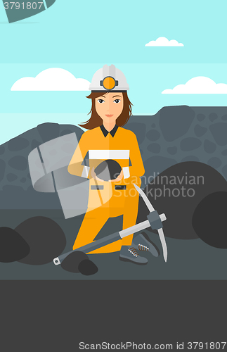 Image of Miner holding coal in hands.