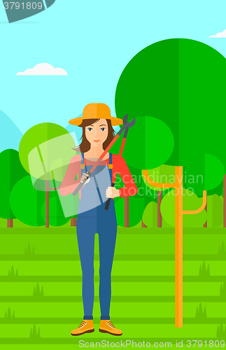 Image of Farmer with pruner in garden.