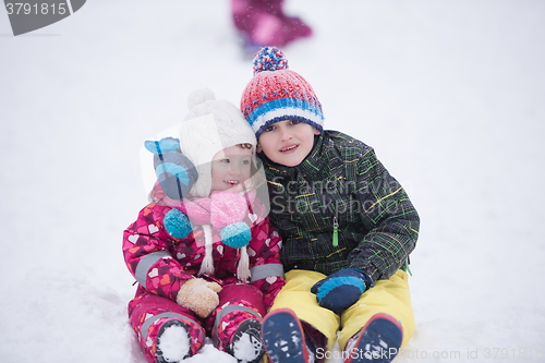 Image of children group  having fun and play together in fresh snow