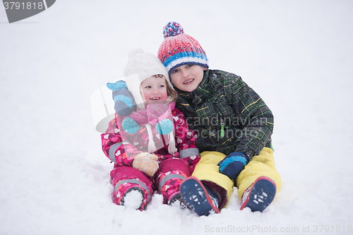 Image of children group  having fun and play together in fresh snow