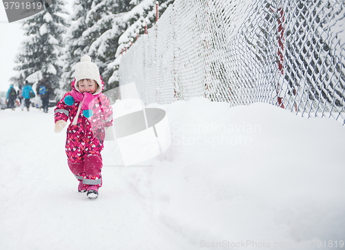 Image of little girl have fun at snowy winter day