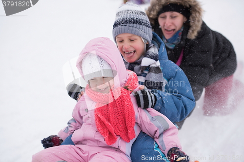 Image of children group  having fun and play together in fresh snow