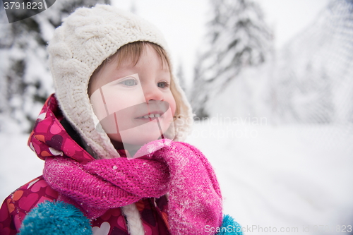 Image of little girl have fun at snowy winter day