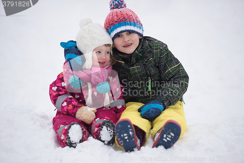 Image of children group  having fun and play together in fresh snow