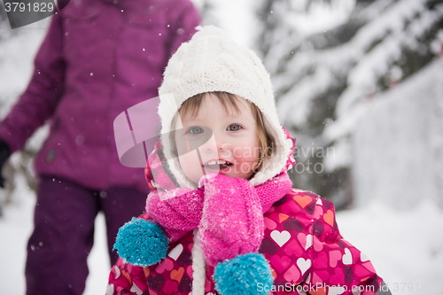 Image of little girl have fun at snowy winter day
