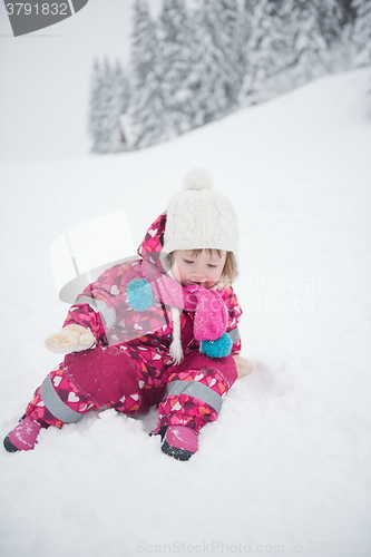 Image of little girl have fun at snowy winter day