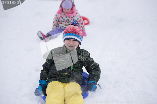 Image of children group  having fun and play together in fresh snow