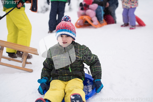 Image of children group  having fun and play together in fresh snow