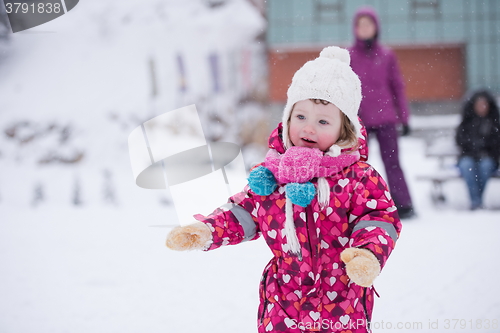 Image of little girl have fun at snowy winter day