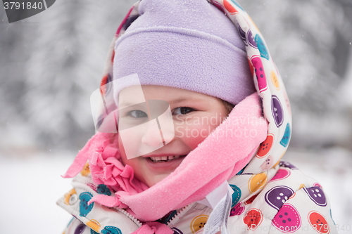 Image of little girl have fun at snowy winter day