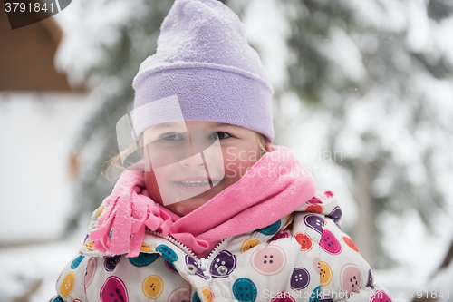 Image of little girl have fun at snowy winter day