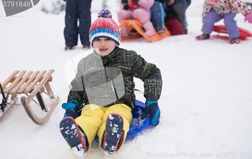 Image of children group  having fun and play together in fresh snow