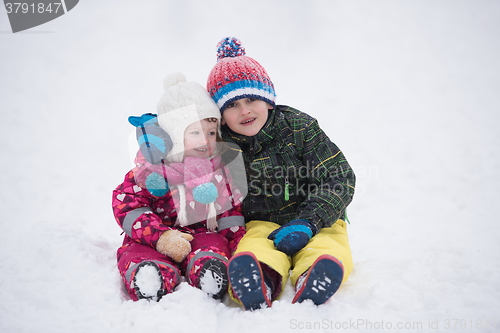 Image of children group  having fun and play together in fresh snow