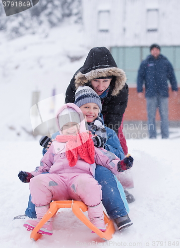 Image of children group  having fun and play together in fresh snow