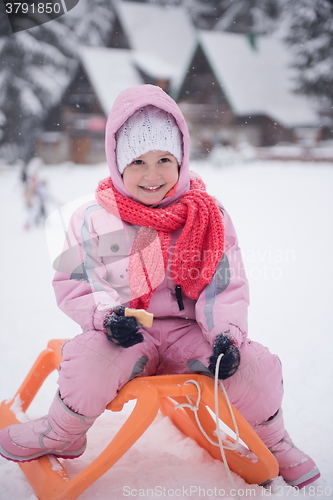 Image of little girl sitting on sledges