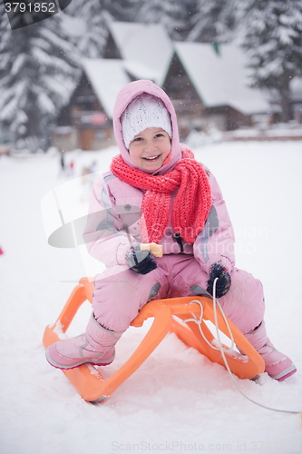 Image of little girl sitting on sledges