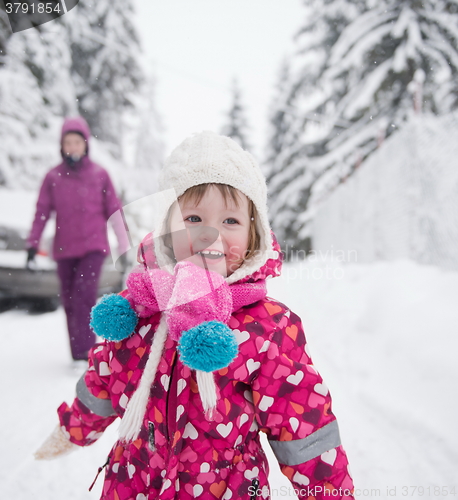 Image of little girl have fun at snowy winter day