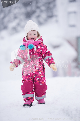 Image of little girl have fun at snowy winter day