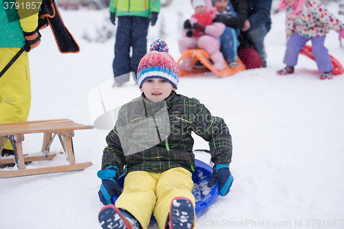 Image of children group  having fun and play together in fresh snow