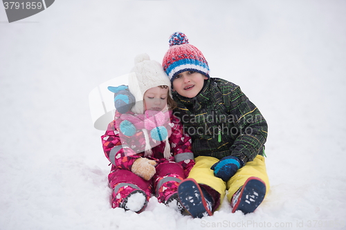 Image of children group  having fun and play together in fresh snow