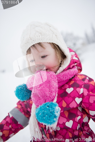 Image of little girl have fun at snowy winter day