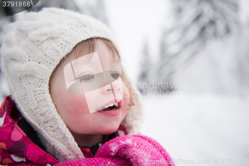 Image of little girl have fun at snowy winter day