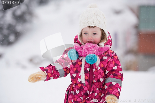 Image of little girl have fun at snowy winter day