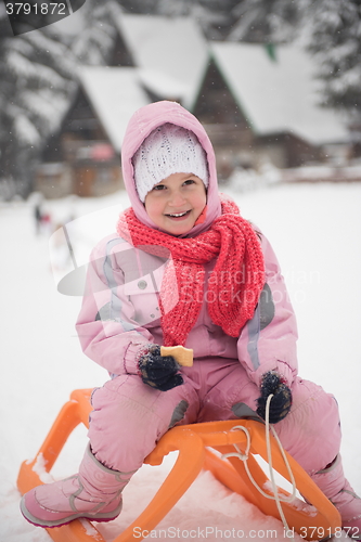 Image of little girl sitting on sledges