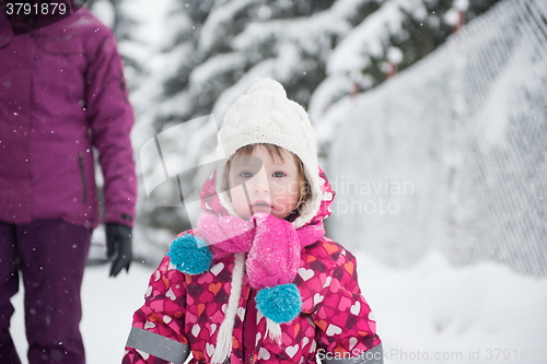 Image of little girl have fun at snowy winter day