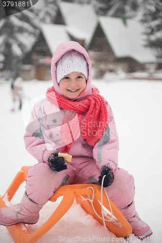 Image of little girl sitting on sledges