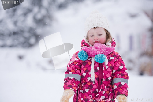 Image of little girl have fun at snowy winter day