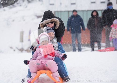 Image of children group  having fun and play together in fresh snow