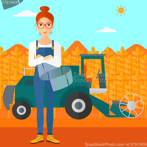 Image of Woman standing with combine on background.