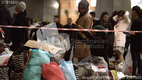 Image of Syrian Refugees Listening to Announcement at Charity Collecting Point in Copenhagen Railroad Station