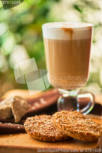 Image of coffee latte cup with cookies