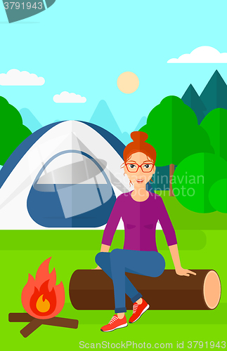 Image of Woman sitting at camp.