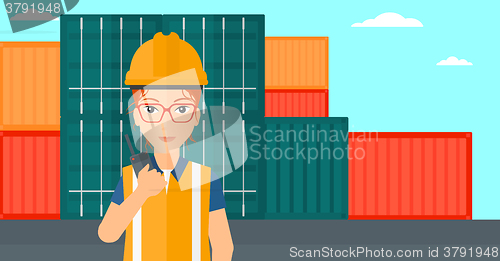 Image of Stevedore standing on cargo containers background.