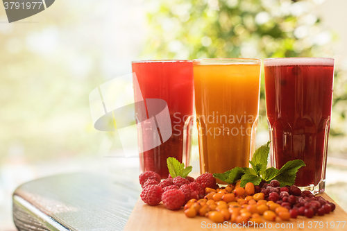 Image of fruit drink with cranberries raspberries and sea buckthorn