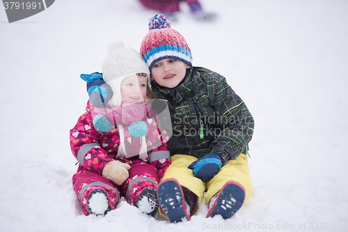 Image of children group  having fun and play together in fresh snow