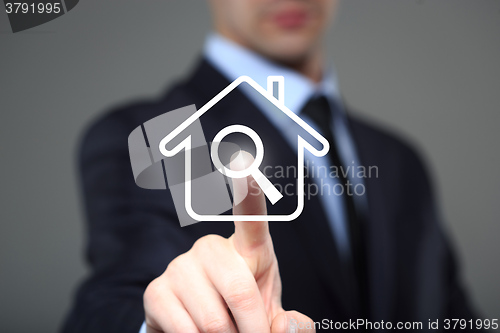 Image of businessman clicks on the icon lodge. search property. The virtual screen