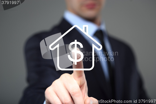 Image of businessman clicks on the icon lodge. dollar sign. The virtual screen