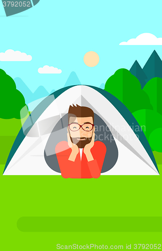 Image of Man lying in tent.
