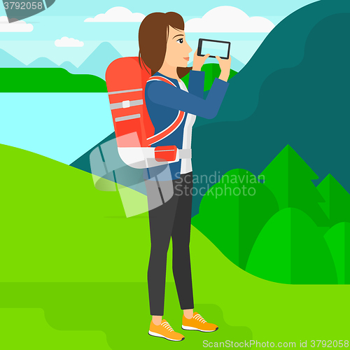 Image of Backpacker taking photo.