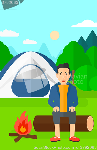 Image of Man sitting at camp.