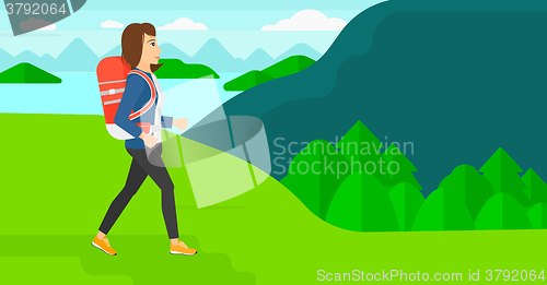 Image of Woman with backpack hiking.