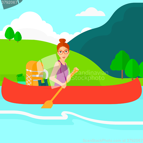 Image of Woman canoeing on the river.