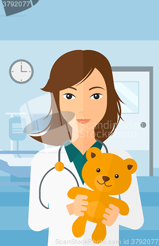 Image of Pediatrician holding teddy bear.