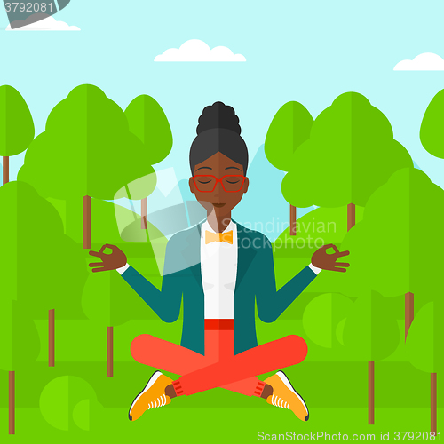 Image of Business woman meditating in lotus pose.